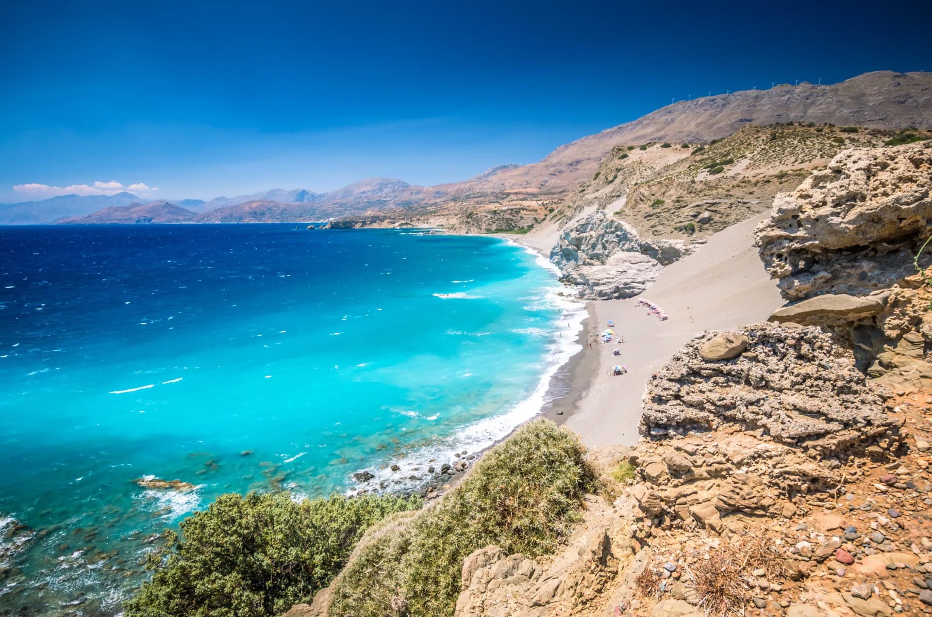 Agios Pavlos Beach in Crete island, Greece. Tourists relax and bath in crystal clear water of St. Paul Sandhill Beach.