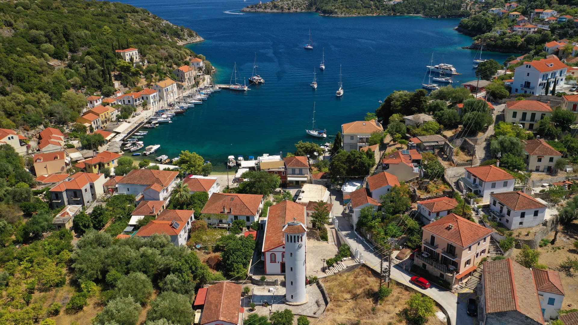 Aerial drone photo of picturesque beautiful seaside village of Kioni a safe anchorage for yachts and sail boats, a true gem of Ithaki or Ithaca island, Ionian, Greece