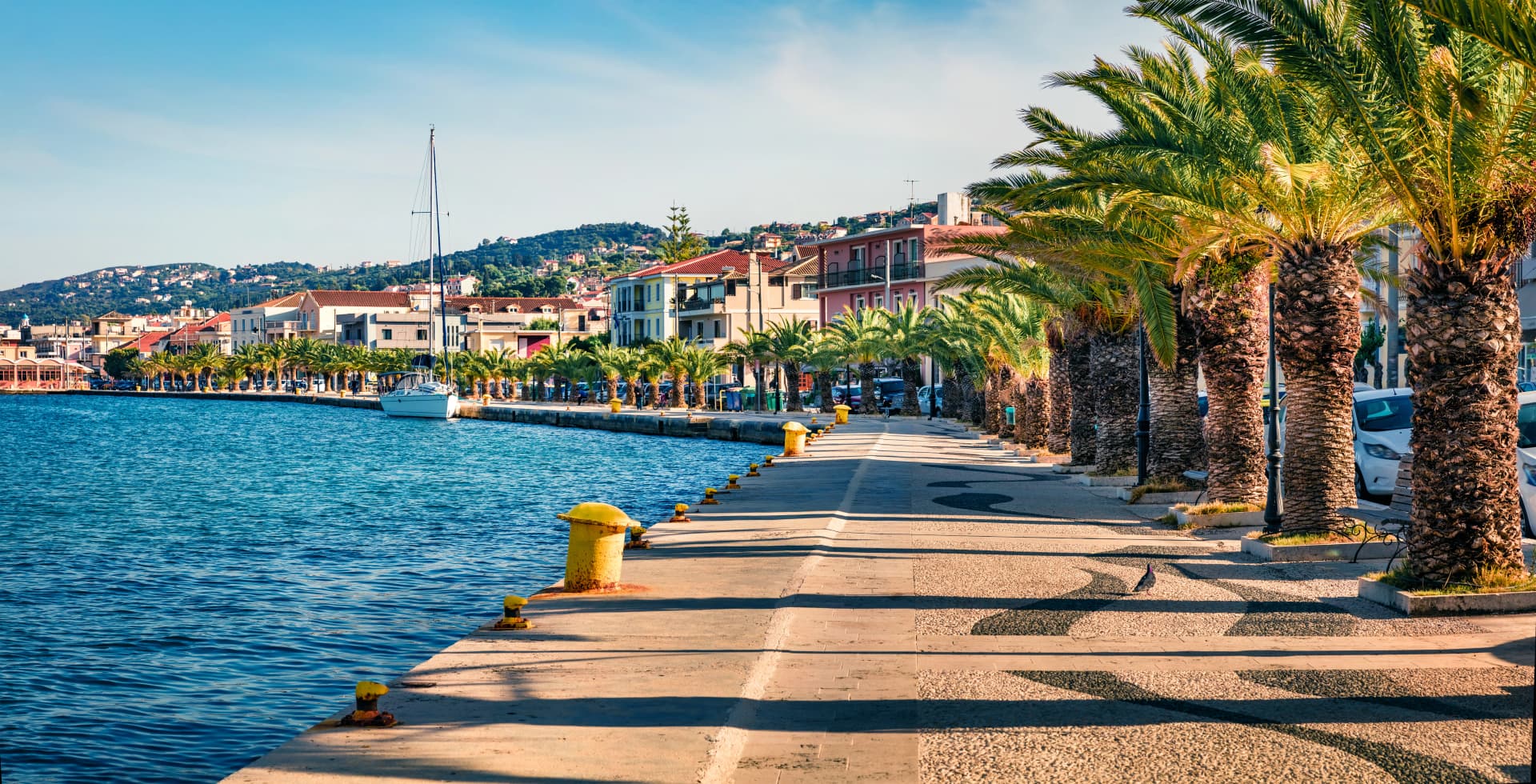 Panoramic spring cityscape of Argostoli port. Colorful morning scene of Kefalonia island, Greece, Europe. Beautiful seascape of Ionian Sea. Traveling concept background.