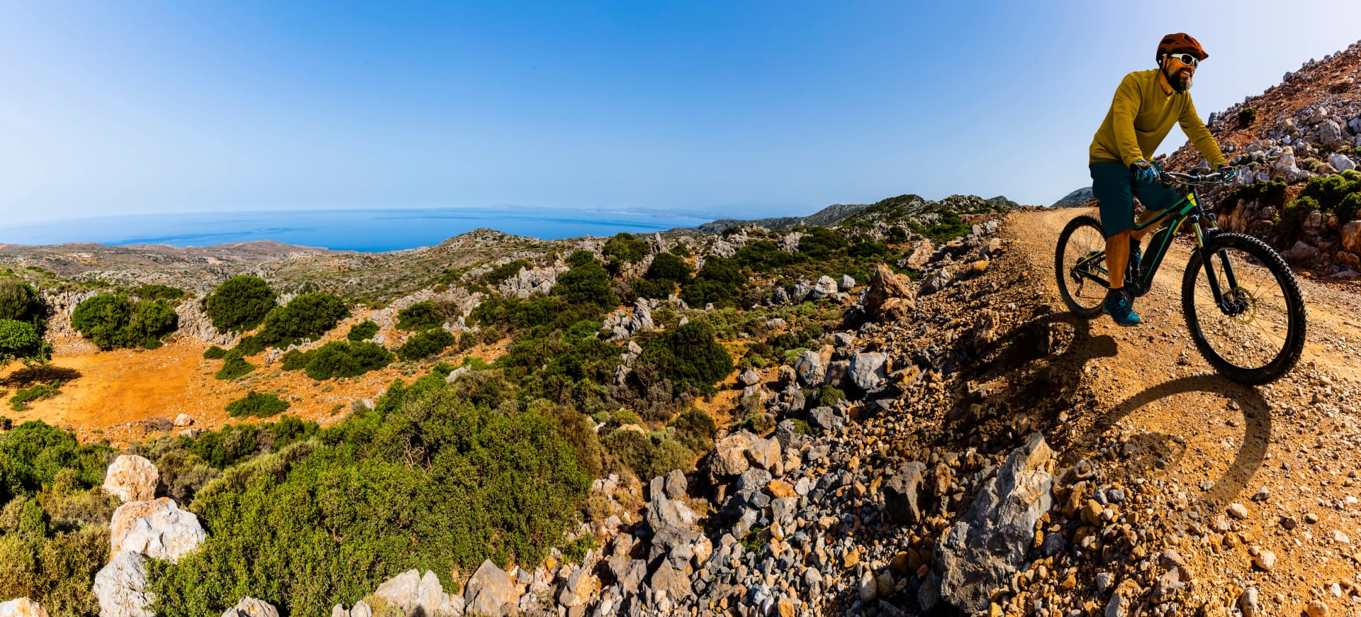 Mountain biker riding on e- bike. Man cycling MTB enduro flow trail track. Outdoor sport activity. Motion Blur picture.
