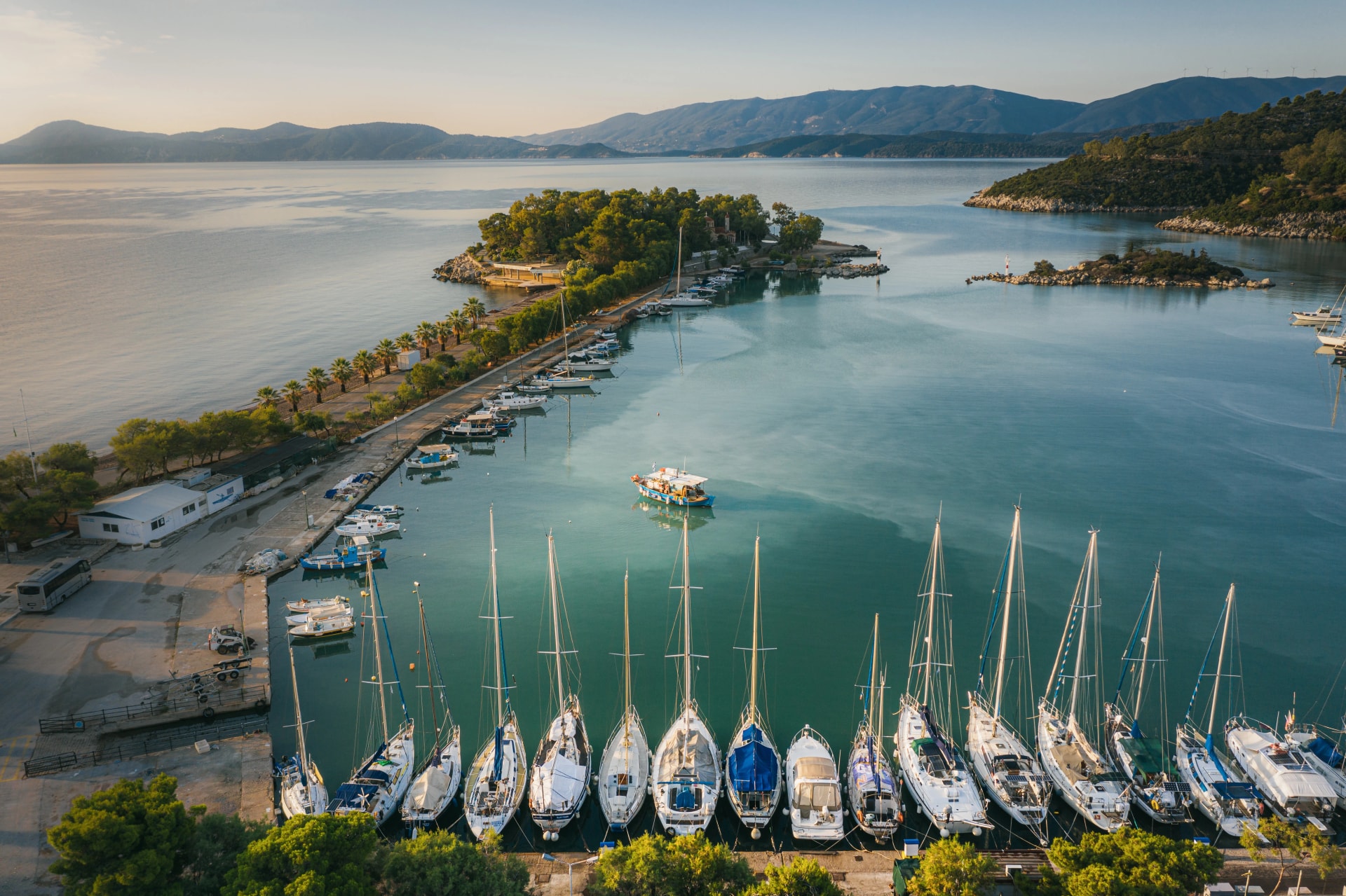 Hot spring and boats in the harbor of town of Methana, Greece